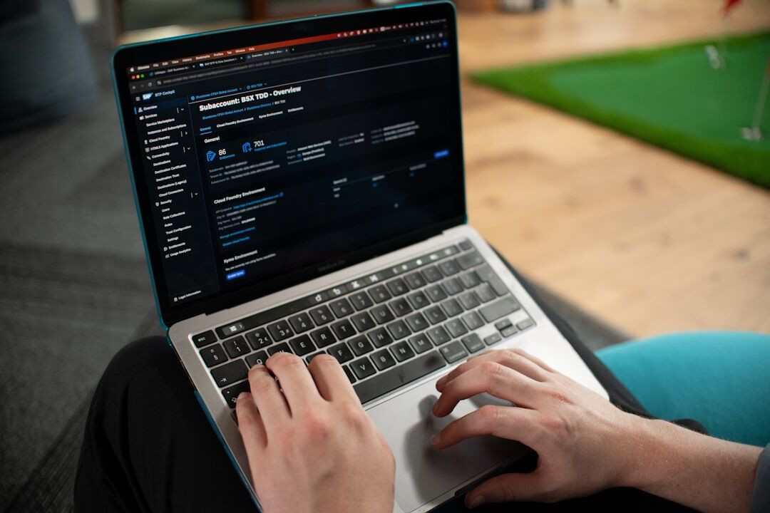 Person working on laptop with code on screen